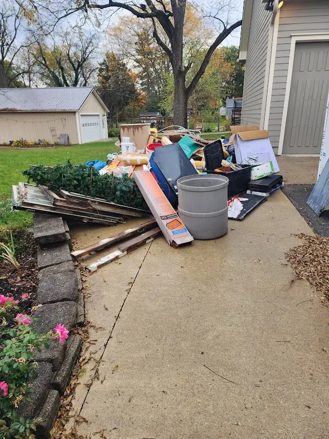 Dumpster being loaded with debris for Estate Cleanout Dumpster Rental in Oak Park